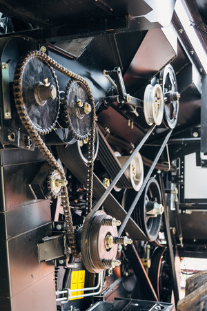 Mechanism of new modern agricultural combine harvester. Gears with chain drive, pulleys with drive...