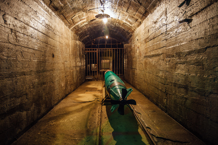 Submarine torpedo in old Soviet underground warship ammunition depot, Sevastopol, Crimeaの写真素材
