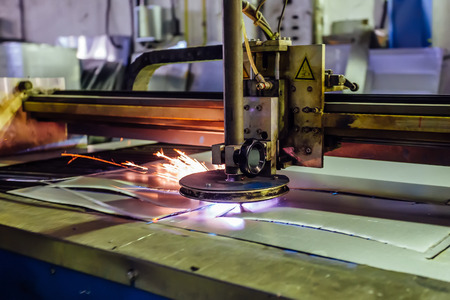 Plasma cut machine cutting steel sheet with sparks. Close up view.の写真素材