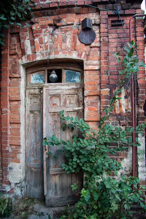 Old wooden door of red brick house.の写真素材