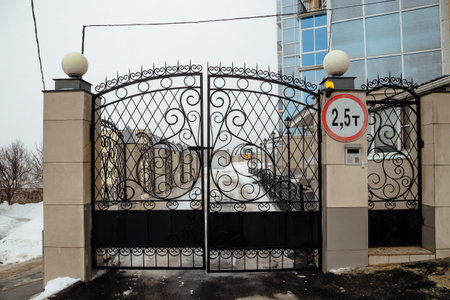 Iron gates with lattice. Entrance to luxury residential area.