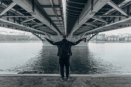 Male tourist photographer with camera under bridge.の写真素材