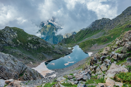 Cold small blue alpine Lake of Waning  Moon in summer season, aerial view.の写真素材