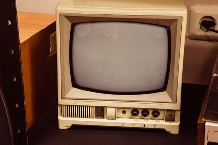 Old small black and white TV in room.