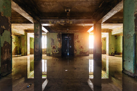 Dark rotten ruined flooded by rains abandoned building. Post-apocalyptic conceptの写真素材