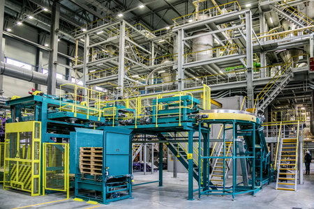 Chemical factory. Thermoplastic production line and packing machinery in large area of industrial...