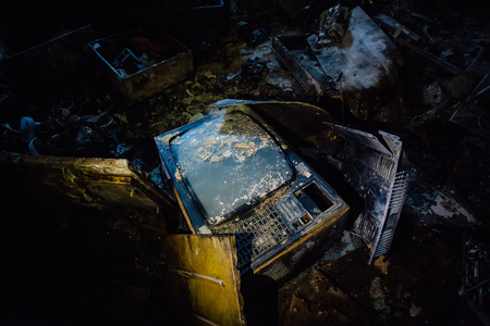 Old broken rotten TV in dark room of abandoned building.の写真素材