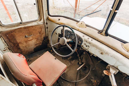 Inside old time abandoned bus driver place. Rusty cabin and broken dashboard.の写真素材
