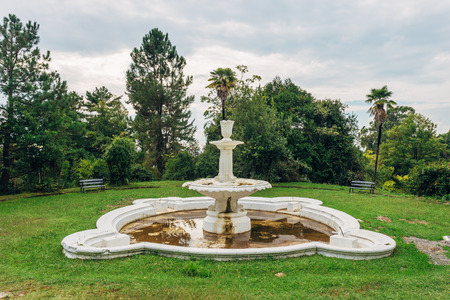 Abandoned old round fountain in old park.の写真素材