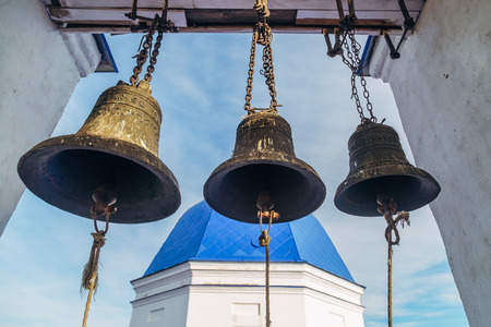 Old bronze bells on church bell towerの写真素材