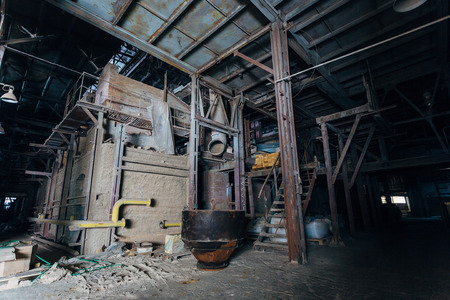 Old brick industrial stove for melting glass in abandoned  factory.の写真素材