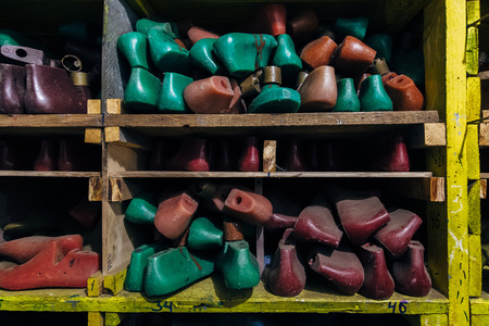 Old multicolored plastic shoe pads on shelves.の写真素材