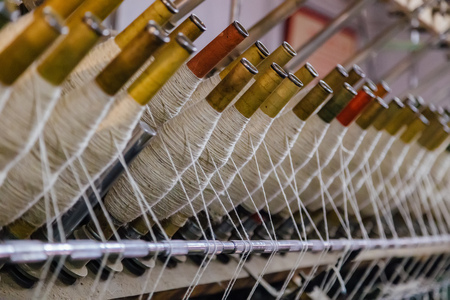 Spindles on spinning machinery, close up viewの写真素材