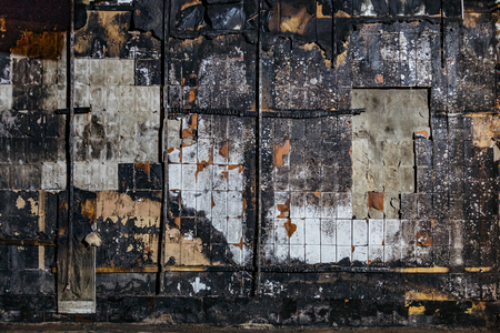 Charred tiled wall backgroundの写真素材