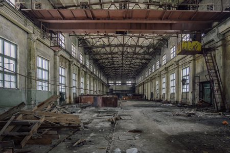 Abandoned industrial building with rusty bridge crane.の写真素材