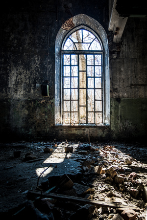 Old broken lancet window inside abandoned building.の写真素材