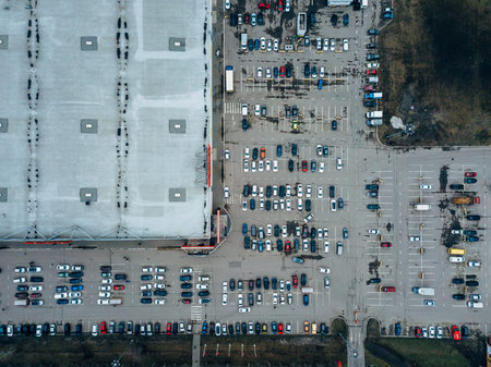 Top view of parking lot near large trade center taken by drone.
