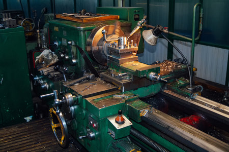 Working lathe in metalworking factory