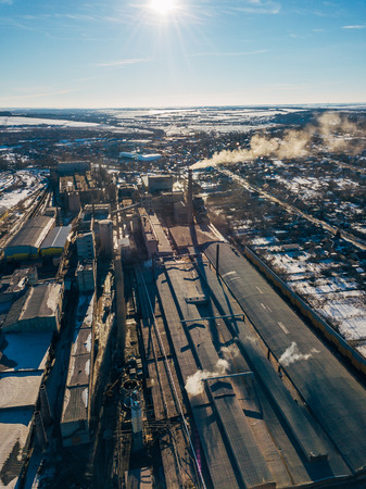 Aerial drone view of industrial area of refractory plant. Fuming pipes of factory. Industrial air pollution concept.の写真素材