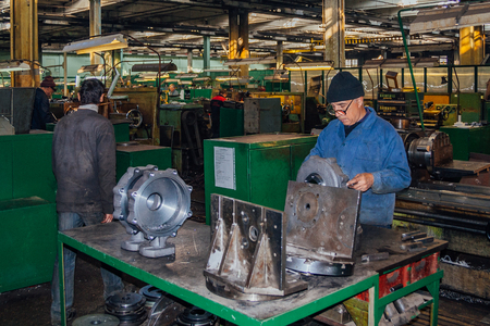 Voronezh, Russia - Circa 2010: Workers assembles machine parts in a factory.のeditorial素材