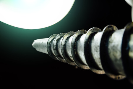 Screw pile on dark background, close up view.の写真素材