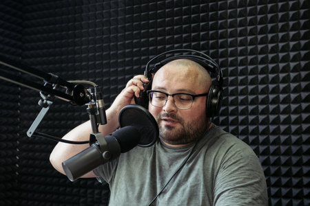 Talking male radio presenter in radio station.