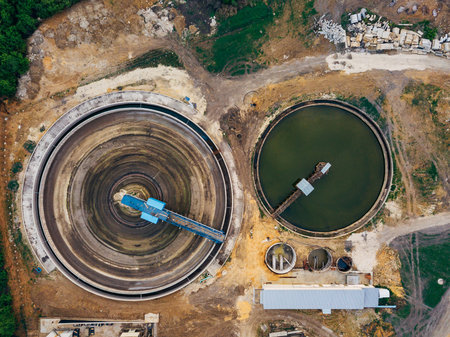 Round clarifiers at wastewater treatment plant, top view from drone
