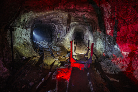 Flooded abandoned uranium mine with rusty rail and trolley.の写真素材