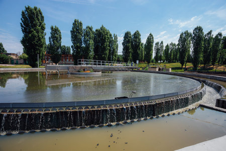 Modern urban sewage treatment plant. Dirty waste water flowing in sedimentation tank.