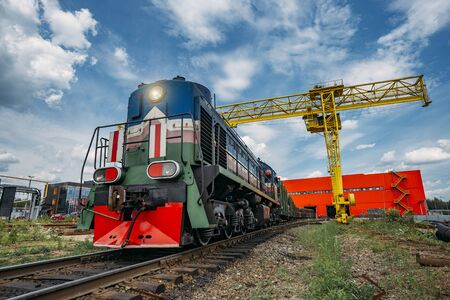 Freight train with new manufactured pipes exits from warehouse.の写真素材