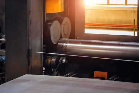 Pipe formation by using roll bending machine, close up.の写真素材