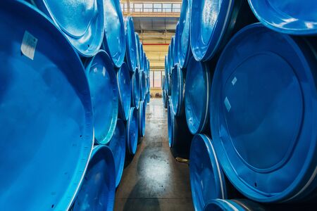 Steel pipes covered with blue caps in warehouse.の写真素材