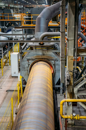 Pipe heating in induction oven for polymer coating.