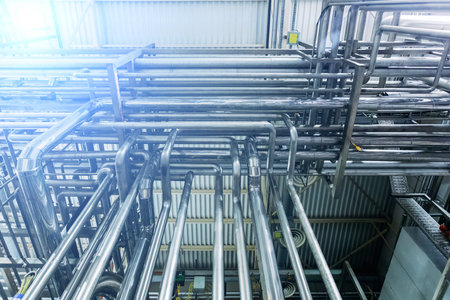 Steel pipes of industrial machinery equipment at chemical or food factory.