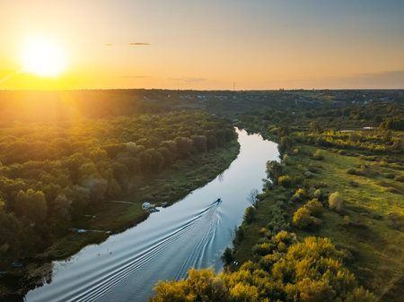 Sunset above forest river, aerial view from drone.の写真素材