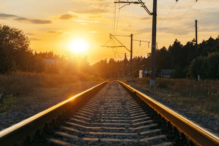 Empty railway track in sunny summer sunset.の写真素材