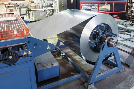 Roll of galvanized steel sheet for manufacturing metal pipes and tubes in the factory.の写真素材