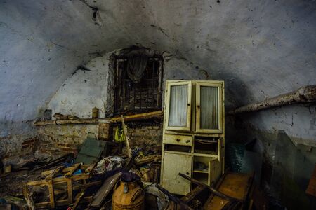 Dirty messy abandoned vaulted underground cellar. Homeless or drug addicts refuge.の写真素材