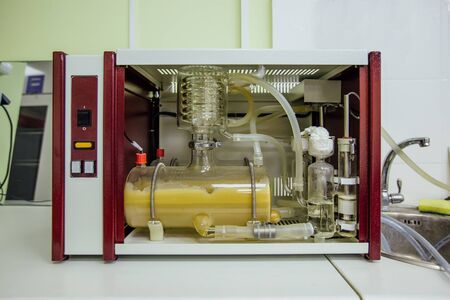 Modern glass coiled electric laboratory water distiller.の写真素材