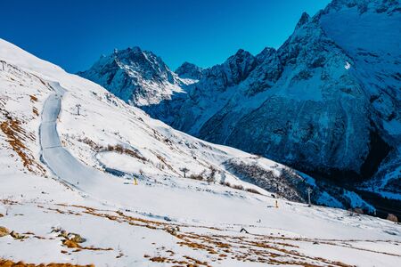 Ski slope in high mountains. Downhill skiing resort.の写真素材