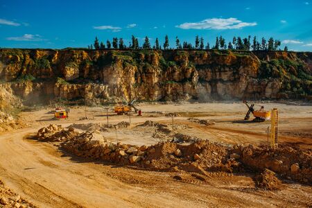Excavarors working on limestone mining in the quarry.の写真素材