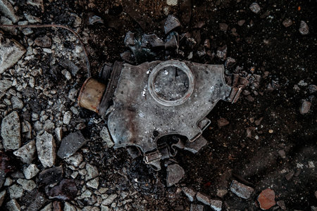 Old rotten Soviet gas mask on dirty floor of abandoned factory.