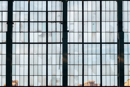 Old broken glass windows at abandoned factory.