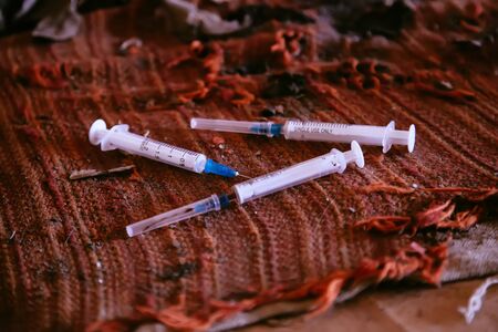 Used by drug addict syringe needle on old cloth.の写真素材