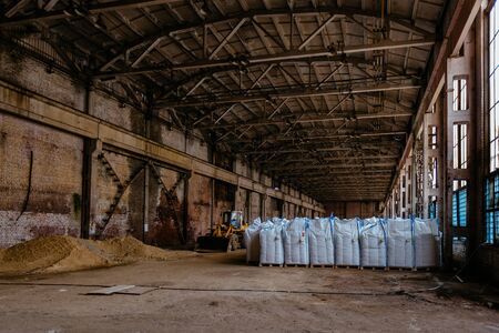 White polyethylene bags with factory products in warehouse.の写真素材