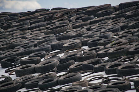 Livestock manure weighted with tires for fermentation covered with vinyl sheet.の写真素材