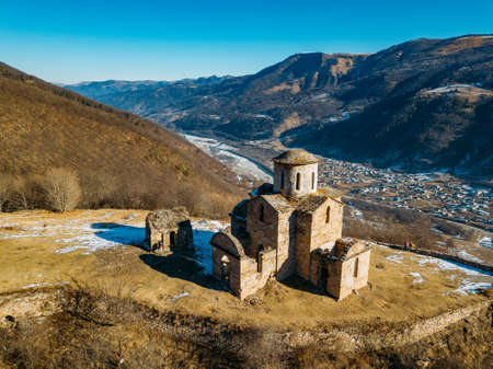 Old abandoned church in North Caucasian mountains, aerial viewの写真素材