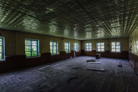 Abandoned school interior, dirty room, rotten peeled walls.の写真素材