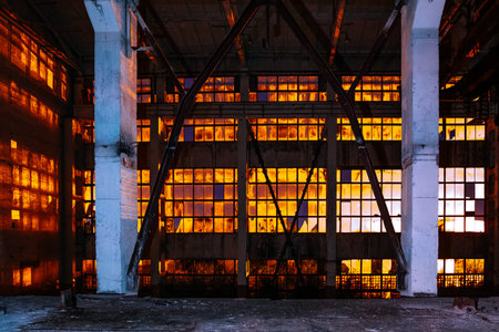 Dark creepy empty abandoned industrial building interior at night.