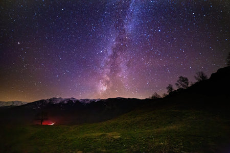 Milky Way Galaxy with stars and mountain landscape.